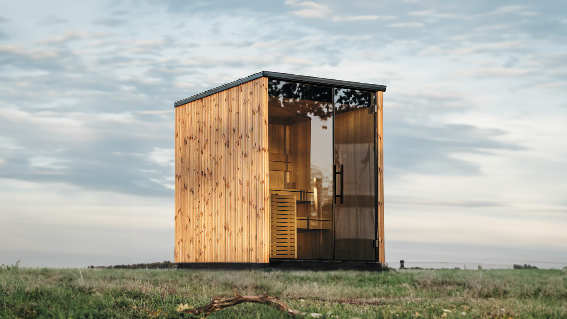 Sauna nordique d'extérieur à façade vitrée, lumière chaude à l'intérieur dans un décor hivernal